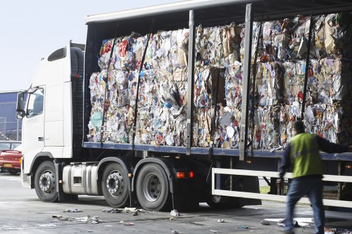 Company logo and skip trucks at depot