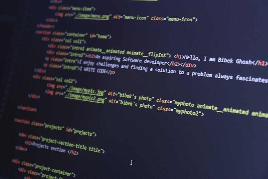 A close-up view of a laptop computer displaying lines of colorful code on its screen, positioned on a wooden desk. To the right of the laptop, there is a ceramic mug with a beige or light brown exteri